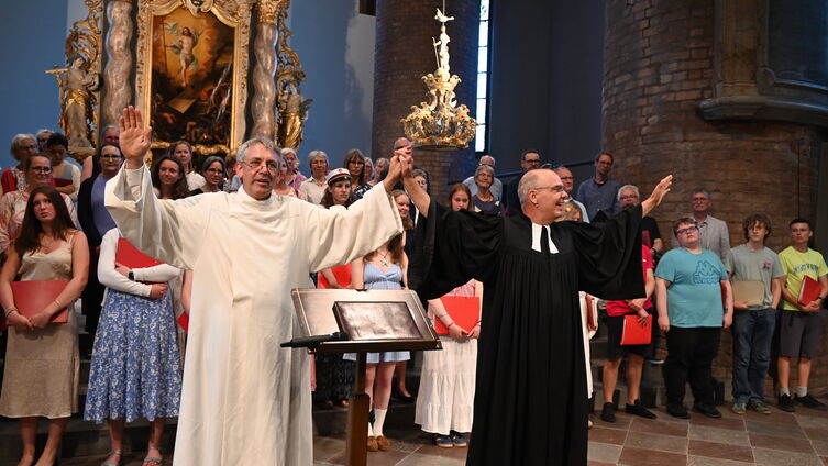 Pastor Dr. Friedrich und Stadtpastor Ahrens segnen die Gemeinde. Im Hintergrund der Chor. Foto: Ahrens