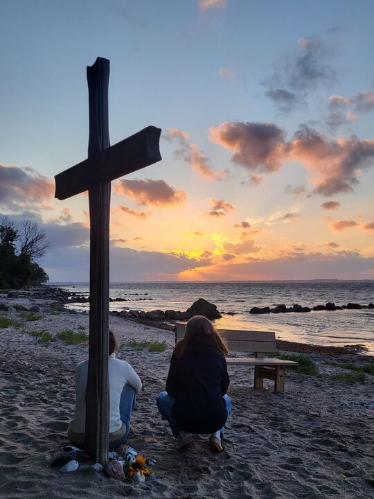 Zwei am Kreuz vor dem Abendhimmel